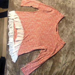 It’s a red and white knitted blouse, size medium.